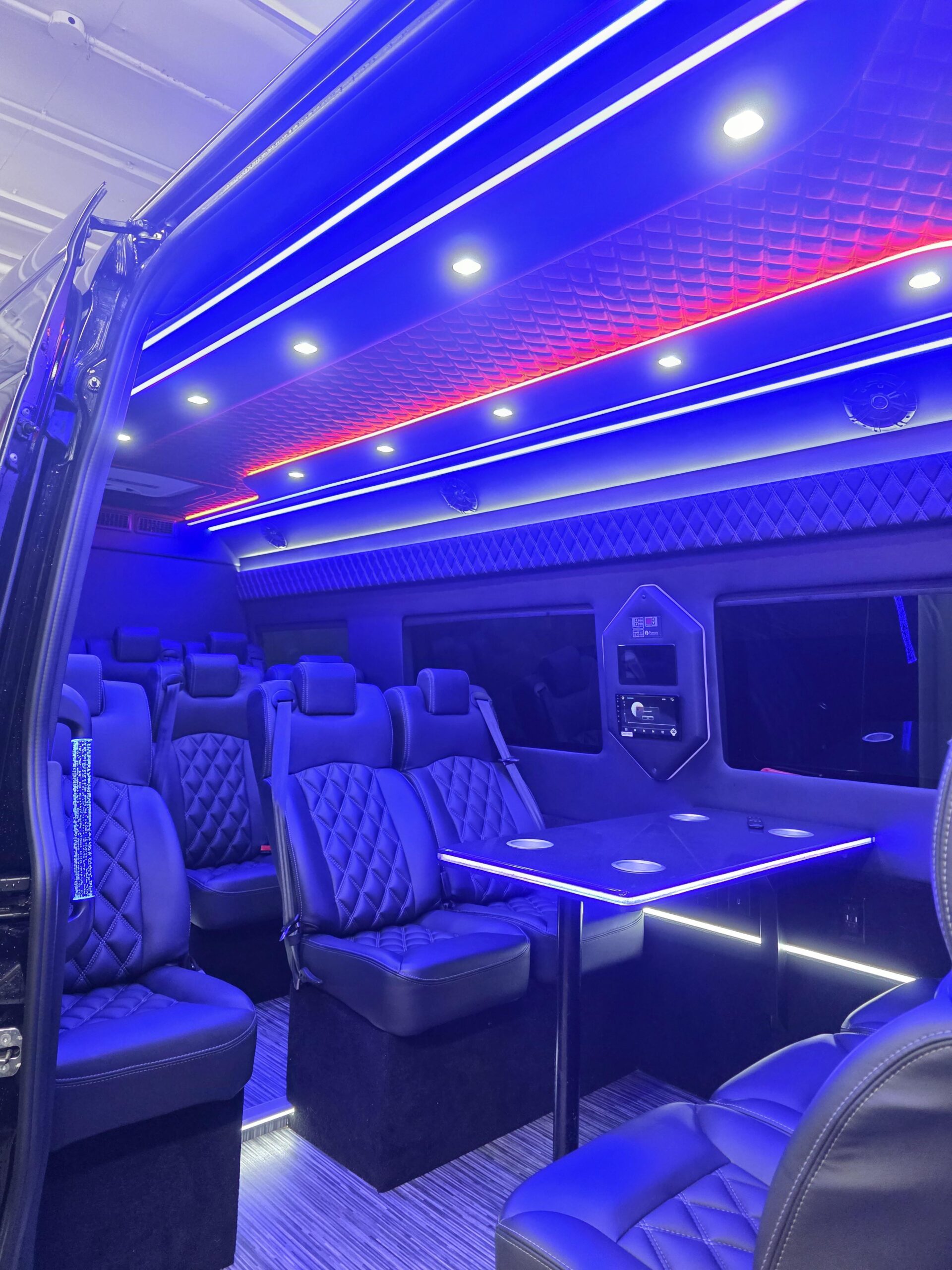 Blue and red light interior NYC Executive Sprinter with table